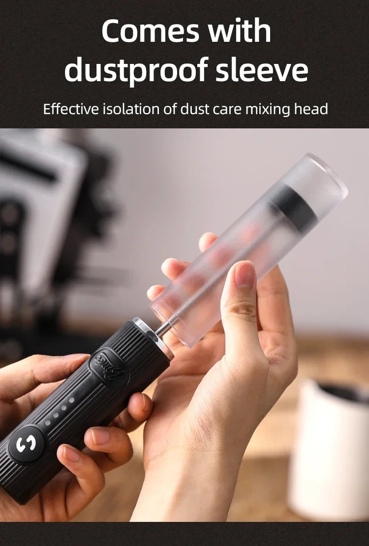 Black handheld electric milk frother with a detachable, translucent plastic dustproof protective sleeve.