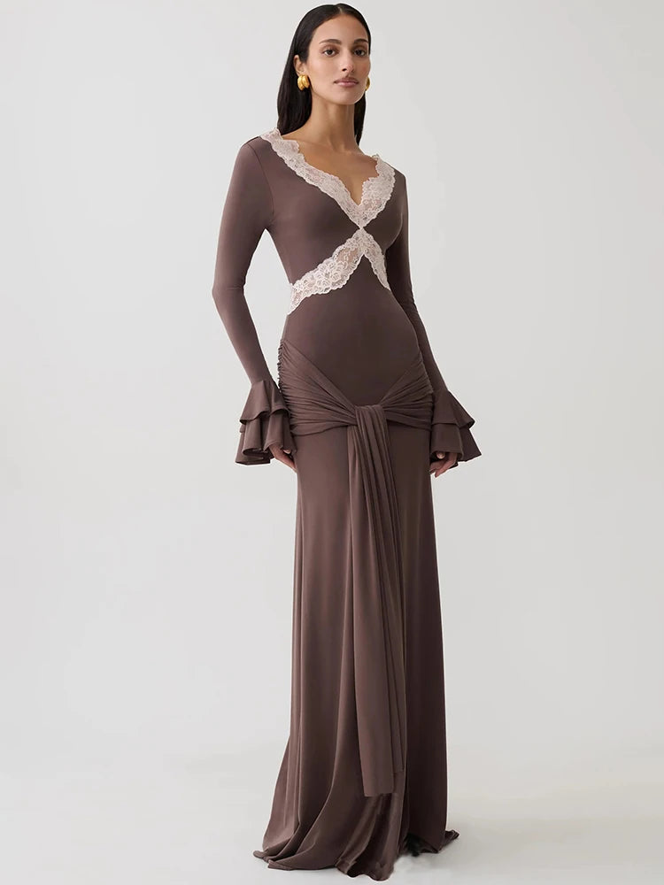Brown maxi bodycon dress with V-neck, lace patchwork, long flare sleeves, and draped waist detail.