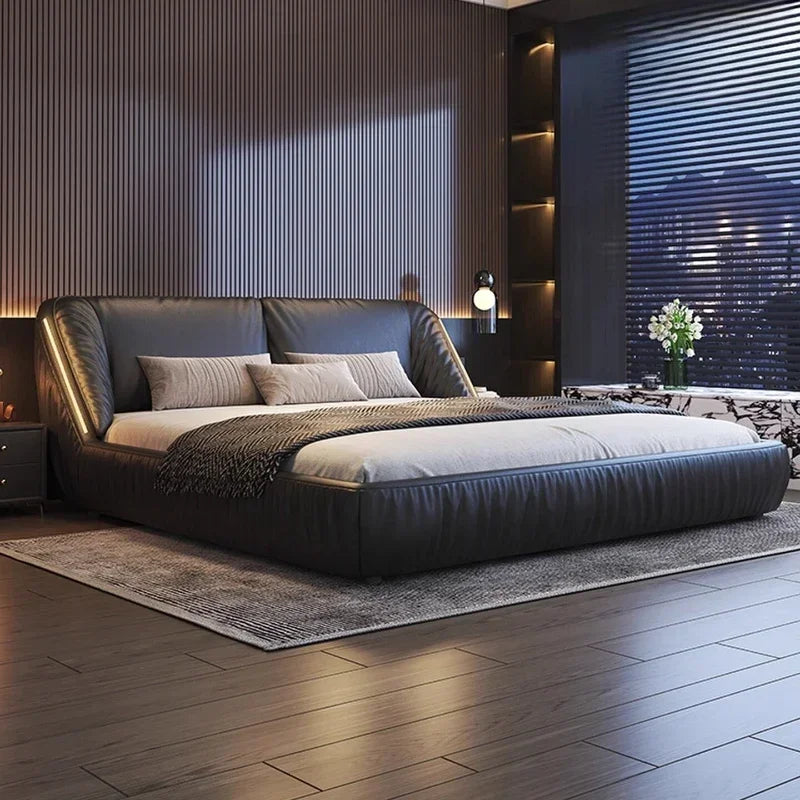 Modern luxury black upholstered king-size bed frame with a sleek, curved silhouette and integrated side lighting.