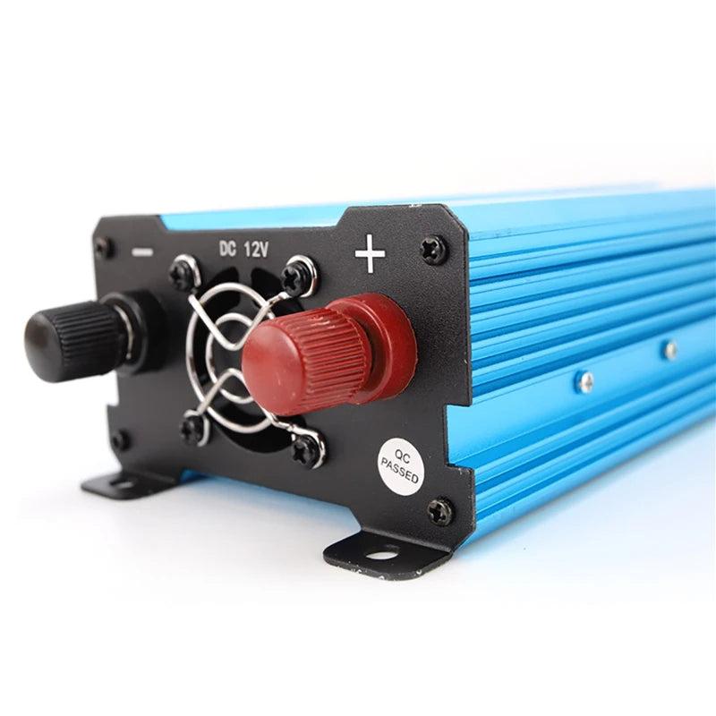 Blue 12V power inverter featuring a ribbed aluminium housing, cooling fan, and positive and negative terminals.