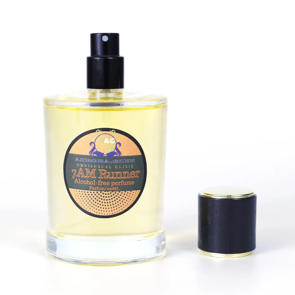 100ml clear glass bottle of golden alcohol-free perfume with a black spray pump and matching lid.