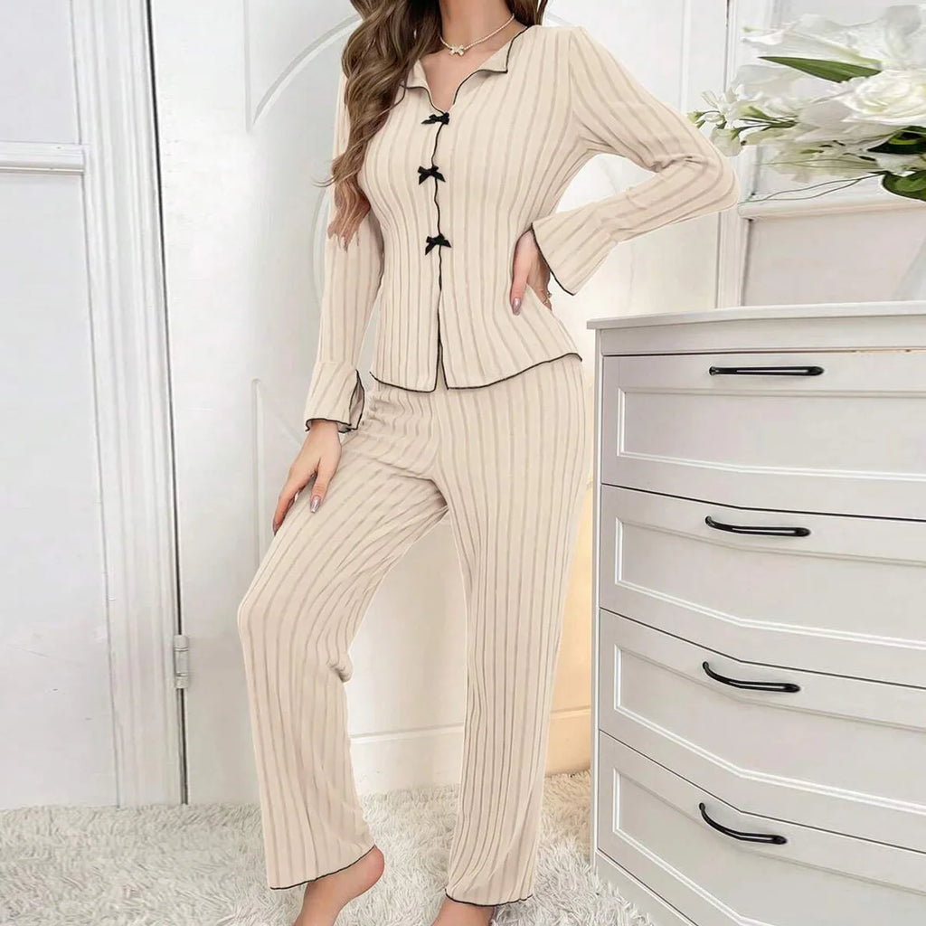 Beige ribbed loungewear set with a button-up top, black trim, and cute bow detailing on the front.