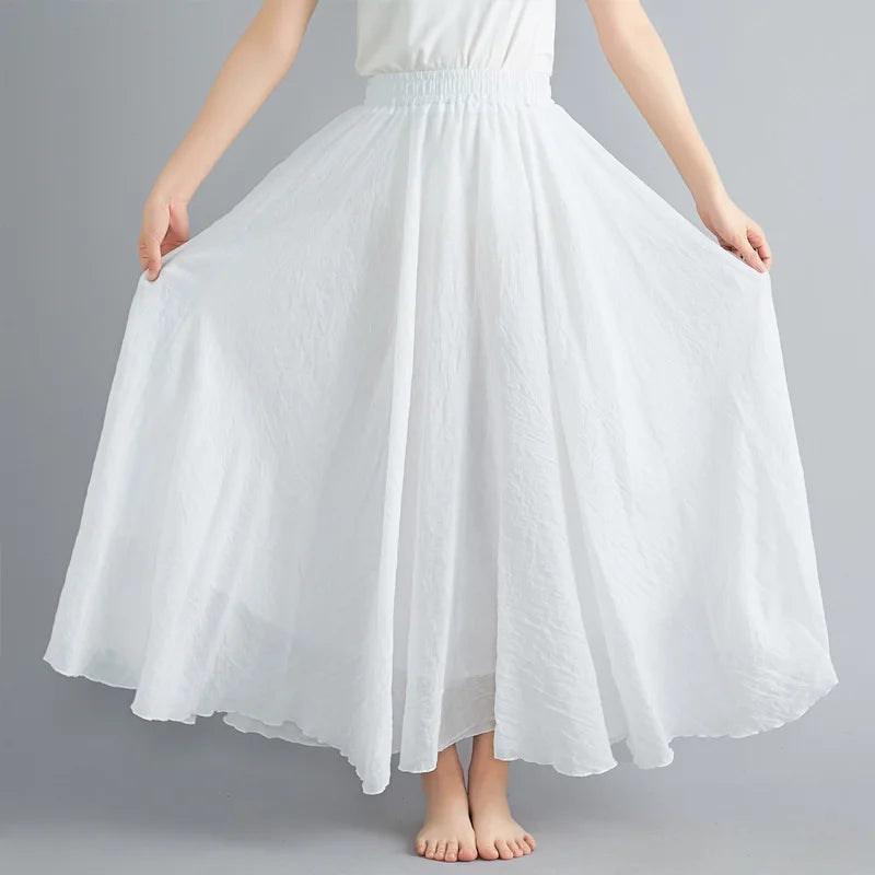 Flowing white maxi skirt with an elasticated waistband and gathered, full-length silhouette.