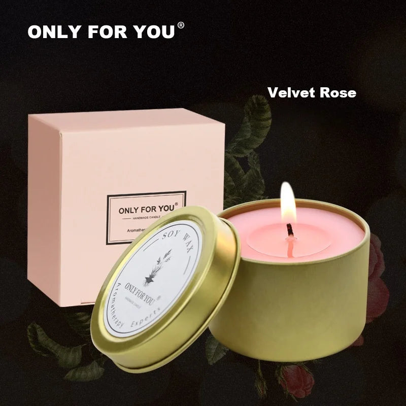 Lit Velvet Rose soy wax candle in a gold tin with a matching pale pink gift box.