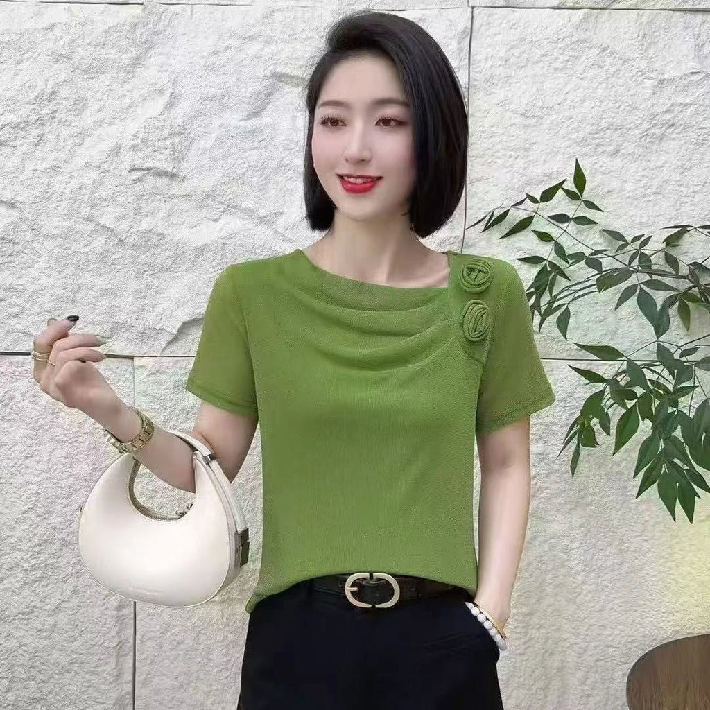 A lime green short-sleeved top with a draped cowl neckline and two decorative floral rosettes on the shoulder.
