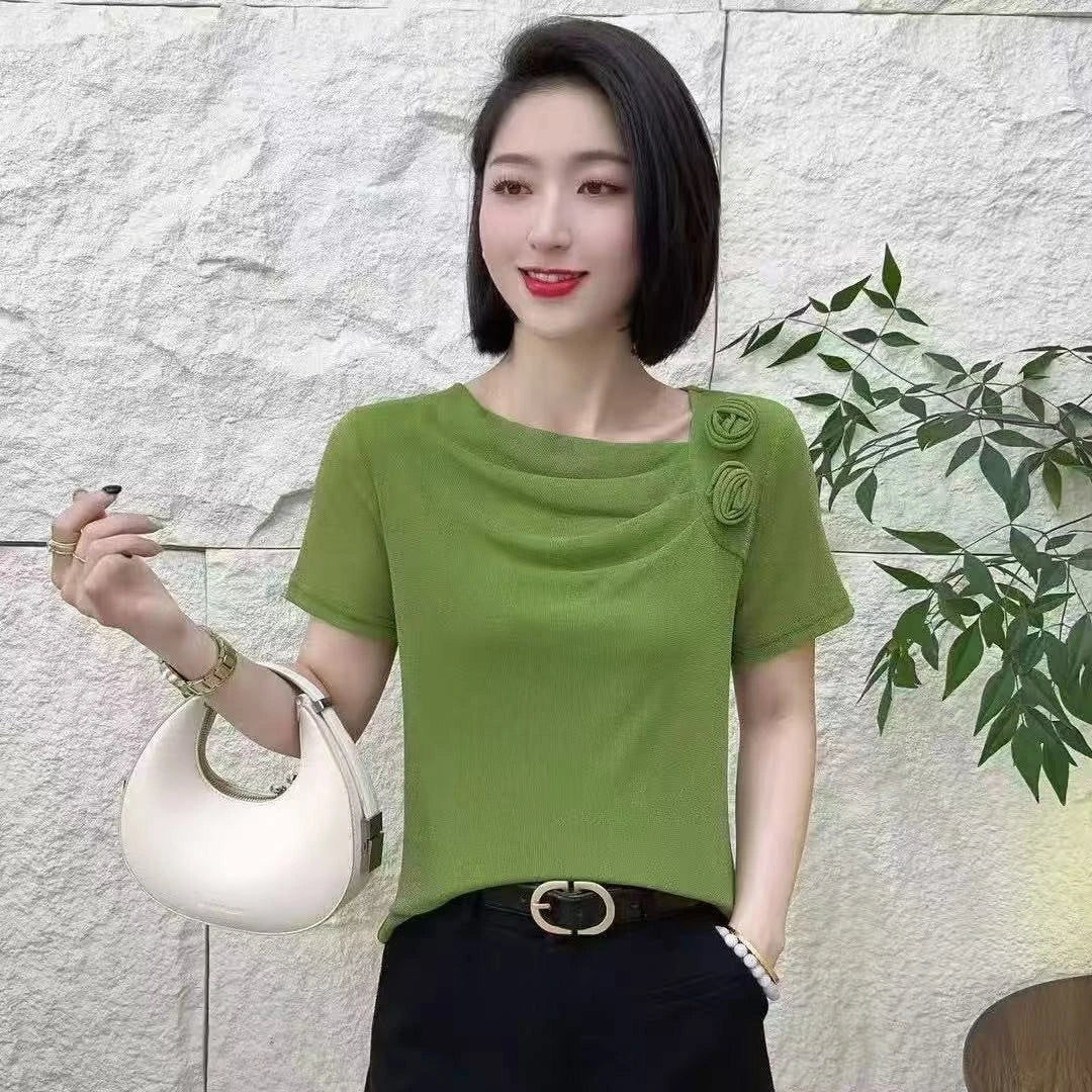 A lime green short-sleeved top with a draped cowl neckline and two decorative floral rosettes on the shoulder.