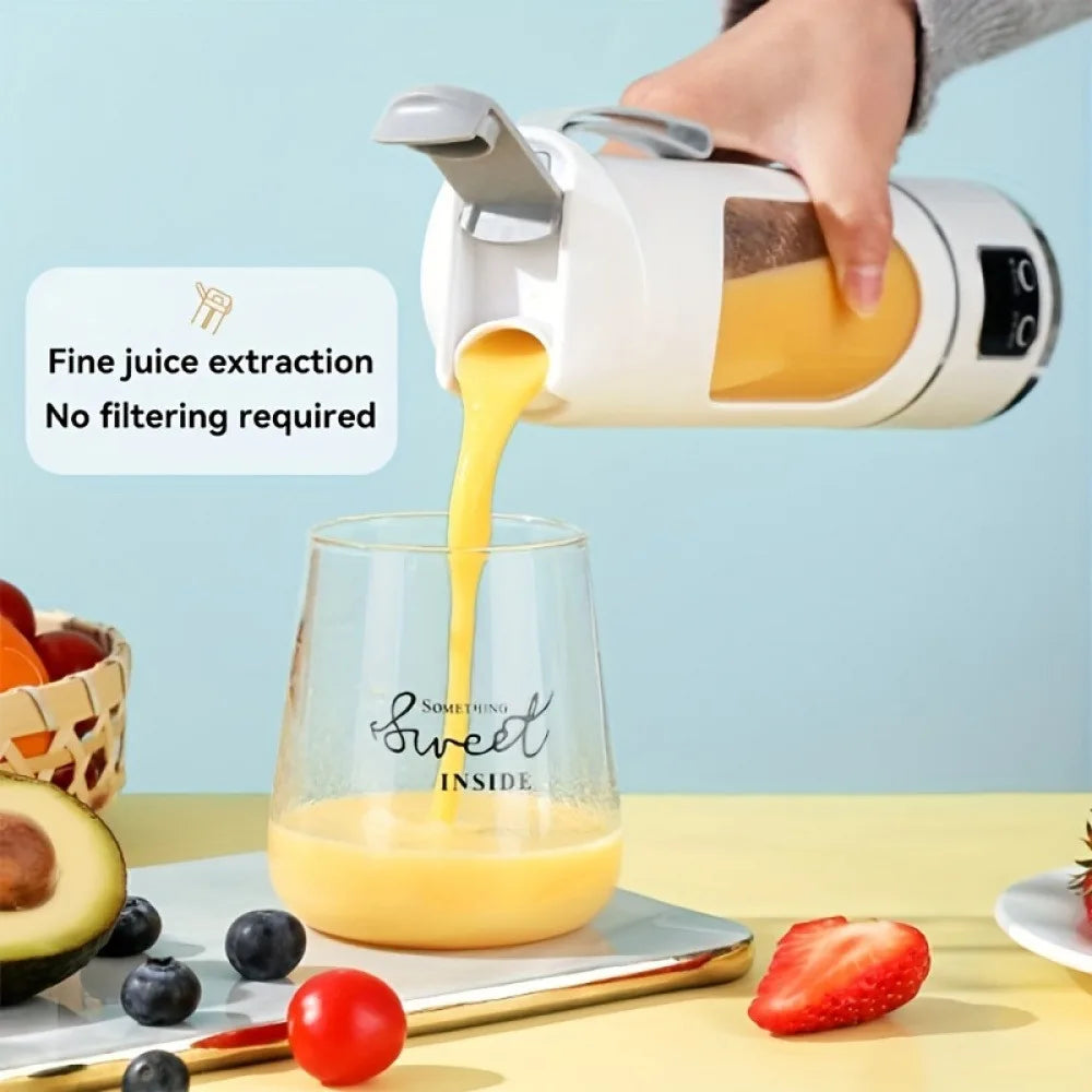 A portable white electric blender pouring yellow juice into a glass cup.