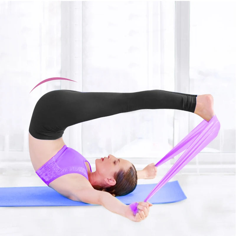 Person doing pilates on a blue mat, using a flat, purple resistance band to stretch their legs.