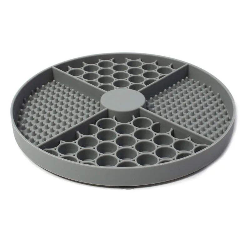 Grey round silicone pet slow feeder mat with four divided sections featuring honeycomb and textured spike patterns.