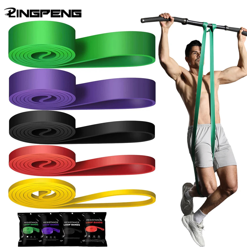 Five colourful heavy-duty resistance bands in green, purple, black, red, and yellow, shown in use for pull-up exercise.