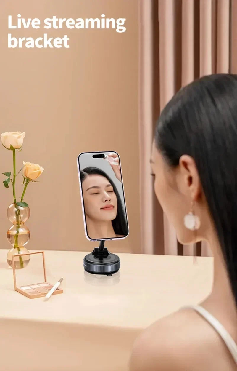 Black adjustable phone stand for live streaming on a desk with a woman using it to apply makeup.