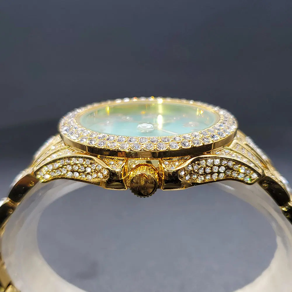 Side view of a gold-tone women's dress watch featuring a light blue dial and sparkling crystal accents throughout.