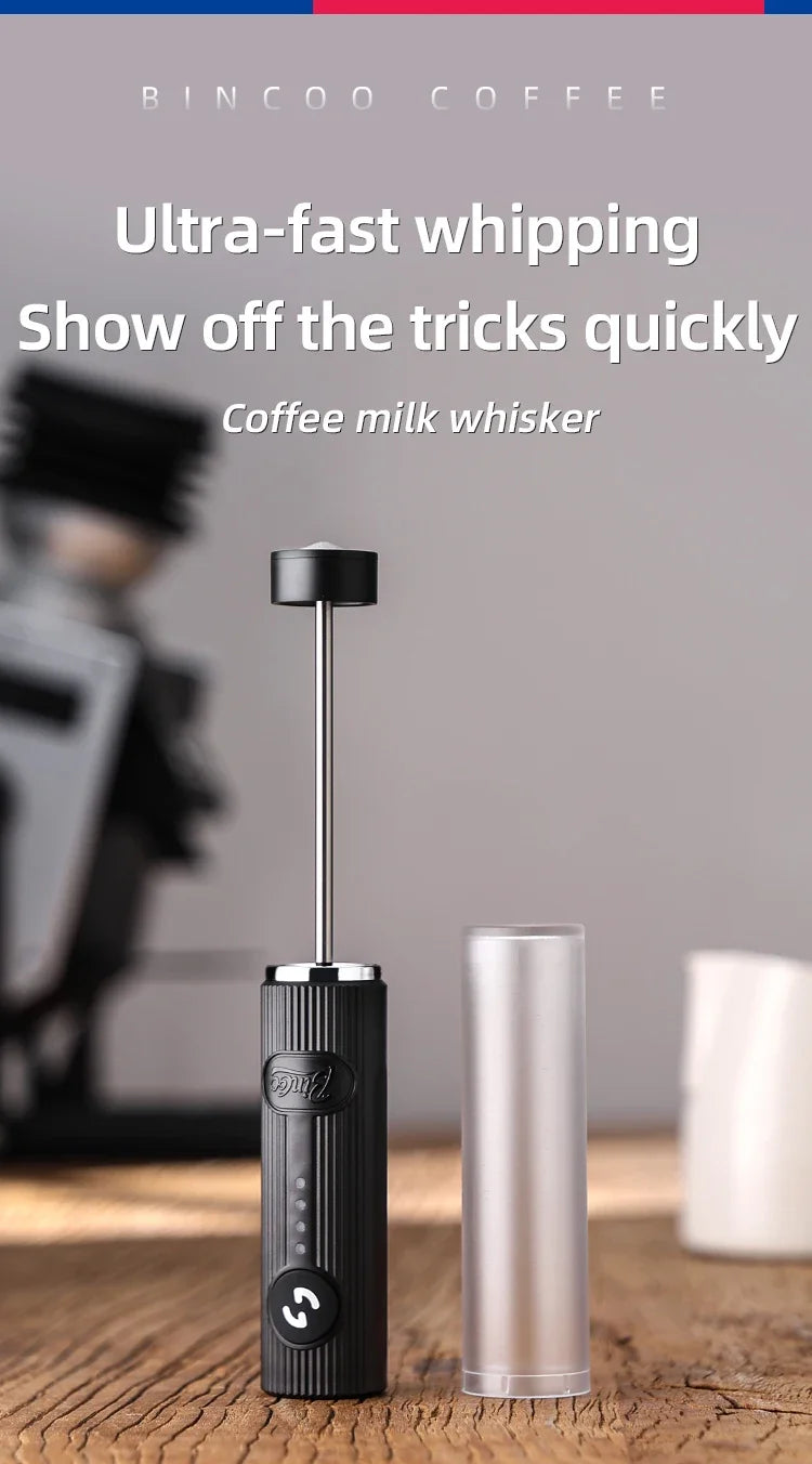 Black handheld electric milk frother with a sleek, ribbed design, thin metal whisk, and clear protective cover.