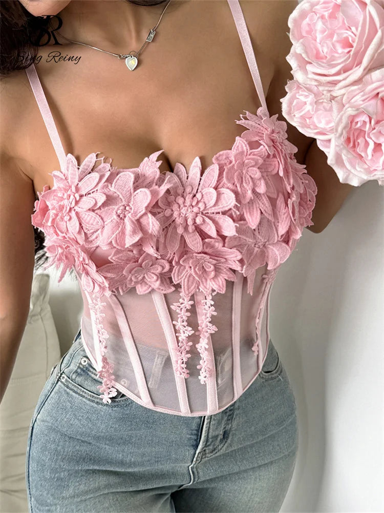 Pink sheer corset top with thin straps, boning, and 3D floral lace appliqués along the sweetheart neckline.