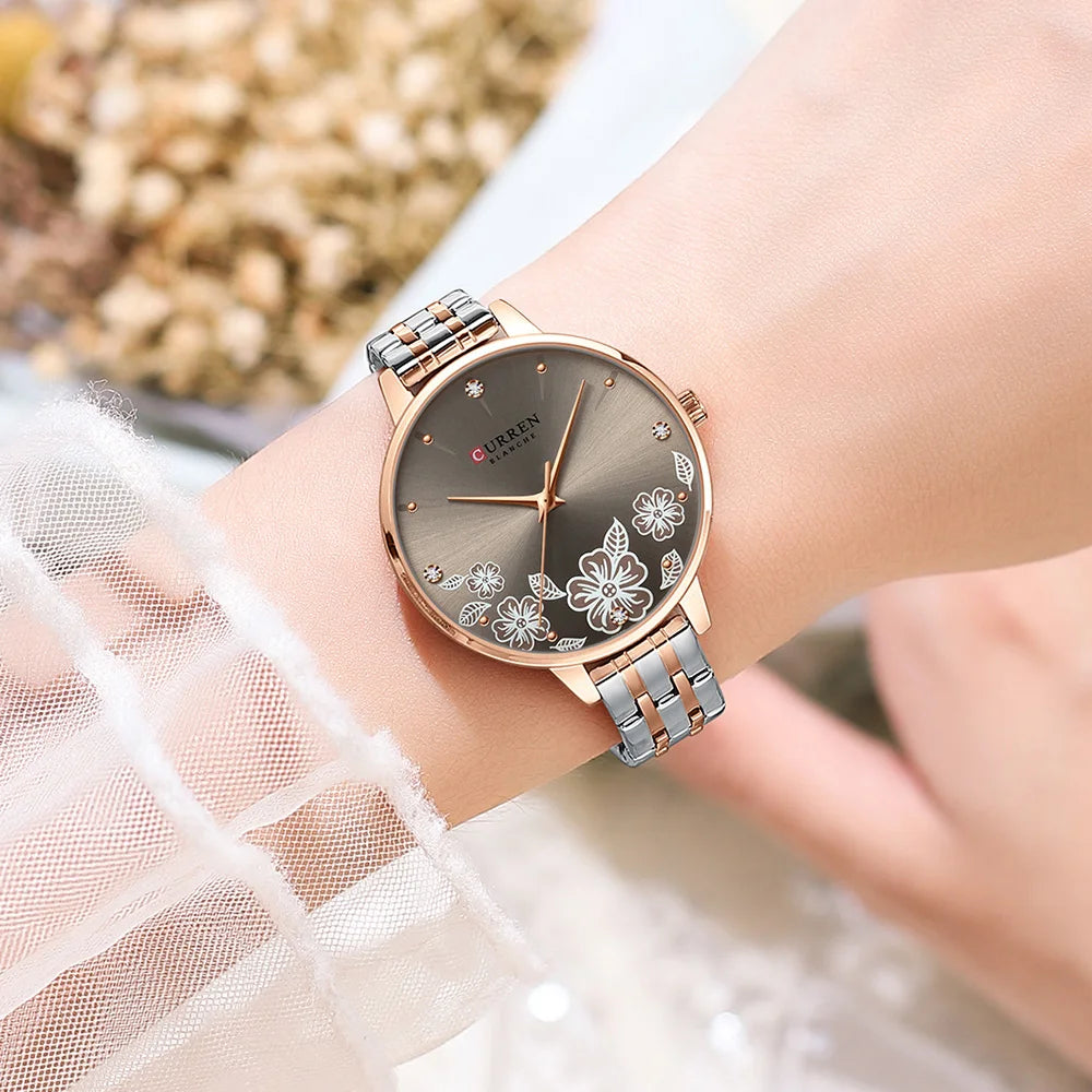 Curren women's ultra-thin quartz watch with round grey dial, white floral art, and two-tone steel bracelet.
