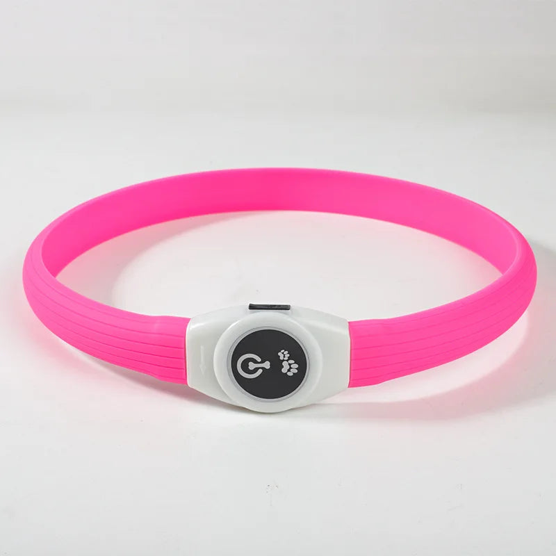 Bright pink LED waterproof dog collar with a white control unit featuring a power button and paw print icon.