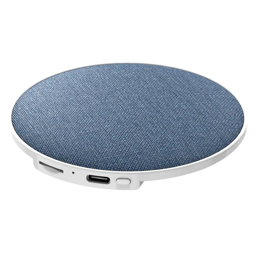 Round, blue fabric-covered wireless under-pillow speaker with a white base, charging port, and power button.