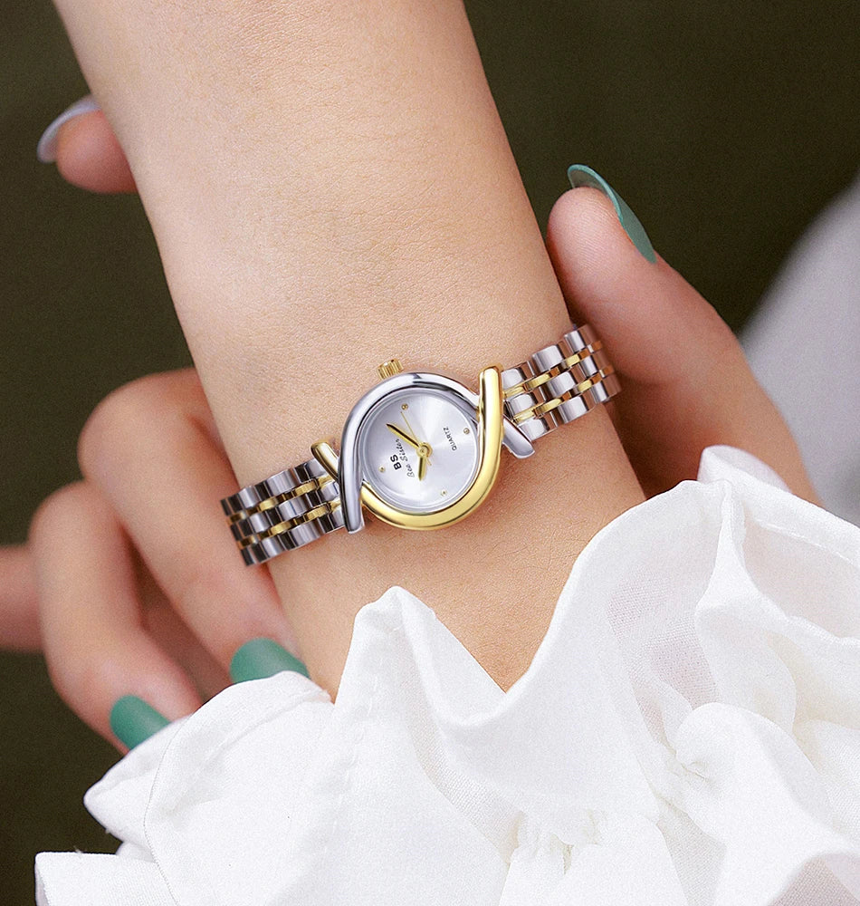 Elegant women’s two-tone silver and gold stainless steel quartz wristwatch with a sleek, curved frame design.