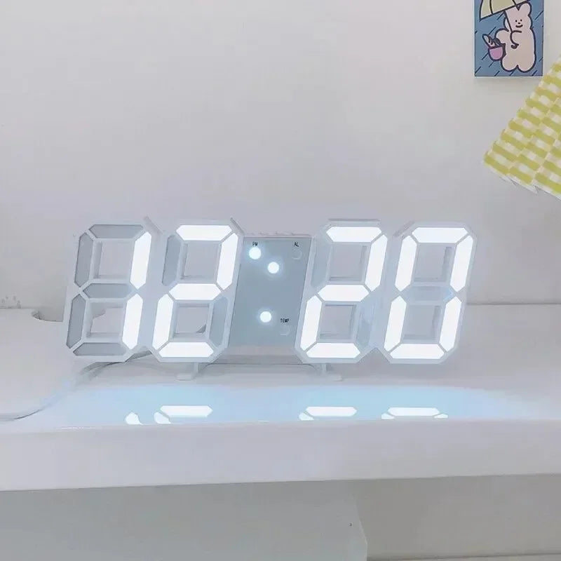 Minimalist white LED digital alarm clock with large, bright white numbers displayed on a white desk surface.
