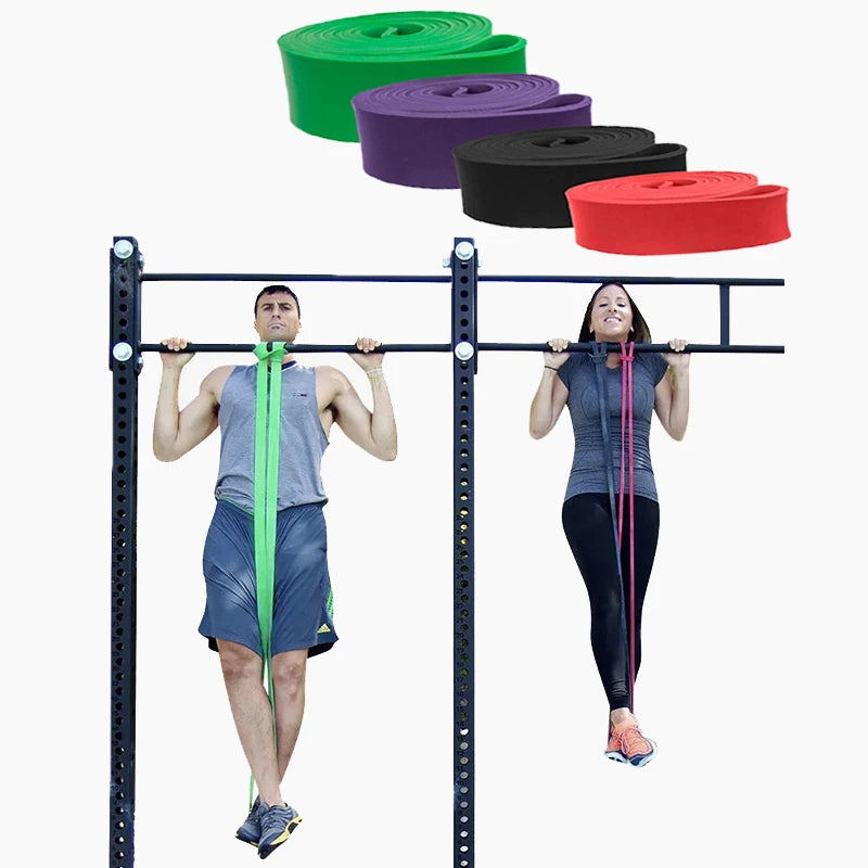 A man and woman using colourful exercise resistance bands to assist with pull-ups on a gym rig.