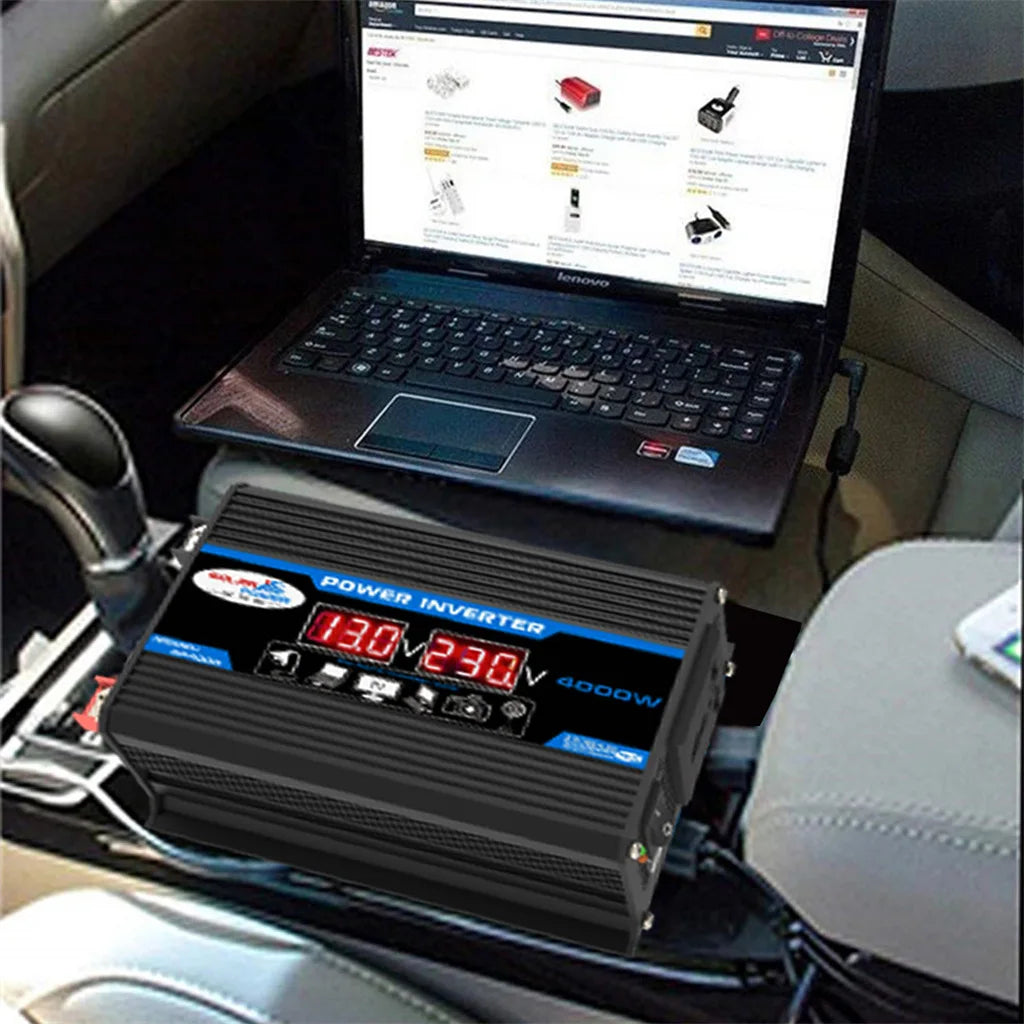Black 4000W car power inverter with a digital voltage display, powering a laptop inside a vehicle.
