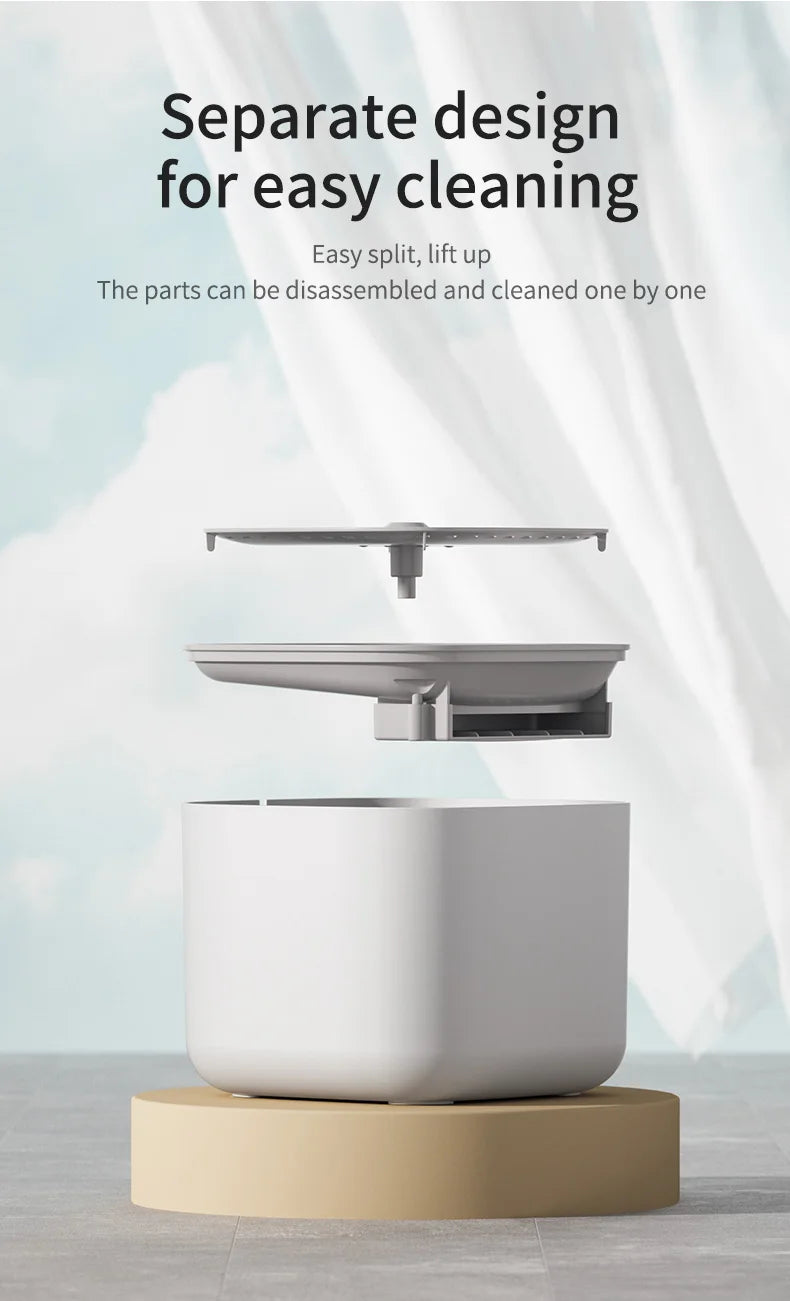 Disassembled light grey pet water fountain with a minimalist, modular design displayed on a tan cylindrical base.