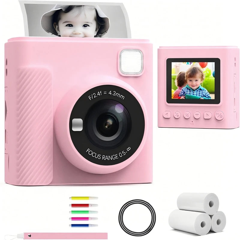 Pink plastic kids' instant print camera with LCD screen, lens, flash, rolls of thermal paper, and markers.