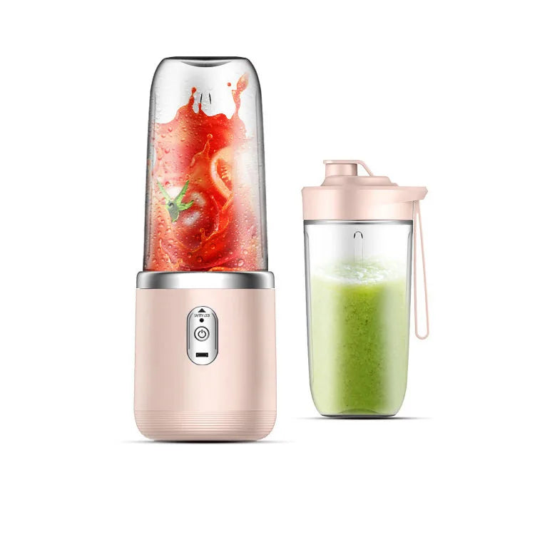 A pastel pink portable blender with a clear cup showing blended ingredients and an extra travel lid on a white background.