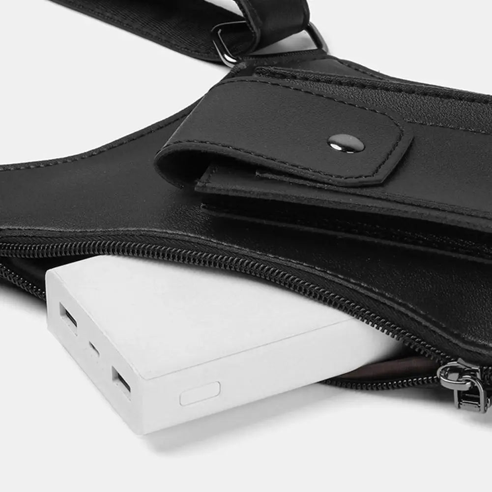 Black tactical shoulder bag featuring a snap-button pocket and a main zipped compartment holding a white power bank.