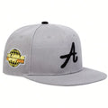Grey baseball cap with a black letter 'A' embroidery and a yellow globe logo on the side. Flat peak hip-hop style.