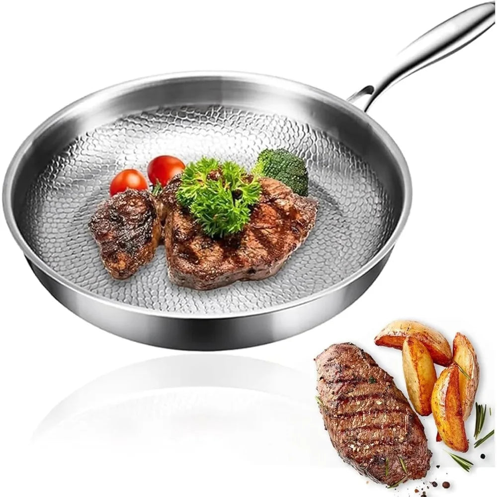Stainless steel frying pan with a textured inner surface containing cooked steak, cherry tomatoes, and broccoli.