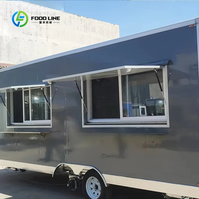 Dark gray mobile food trailer with two service windows, awnings, and a silver diamond-plate base.