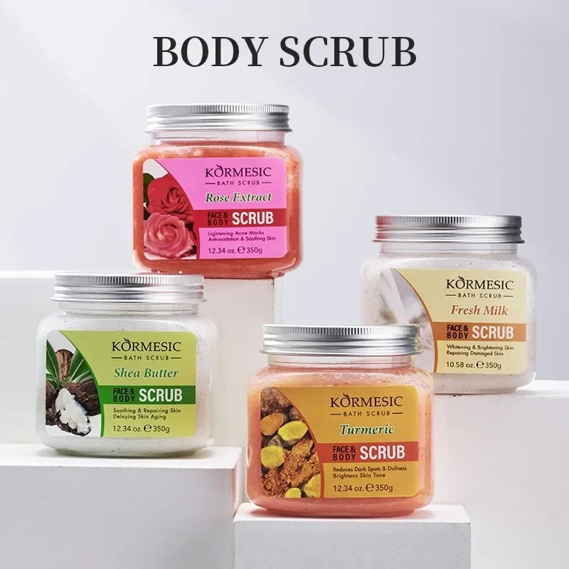 Four jars of face and body scrub in Rose, Shea Butter, Turmeric, and Milk varieties on white display blocks.