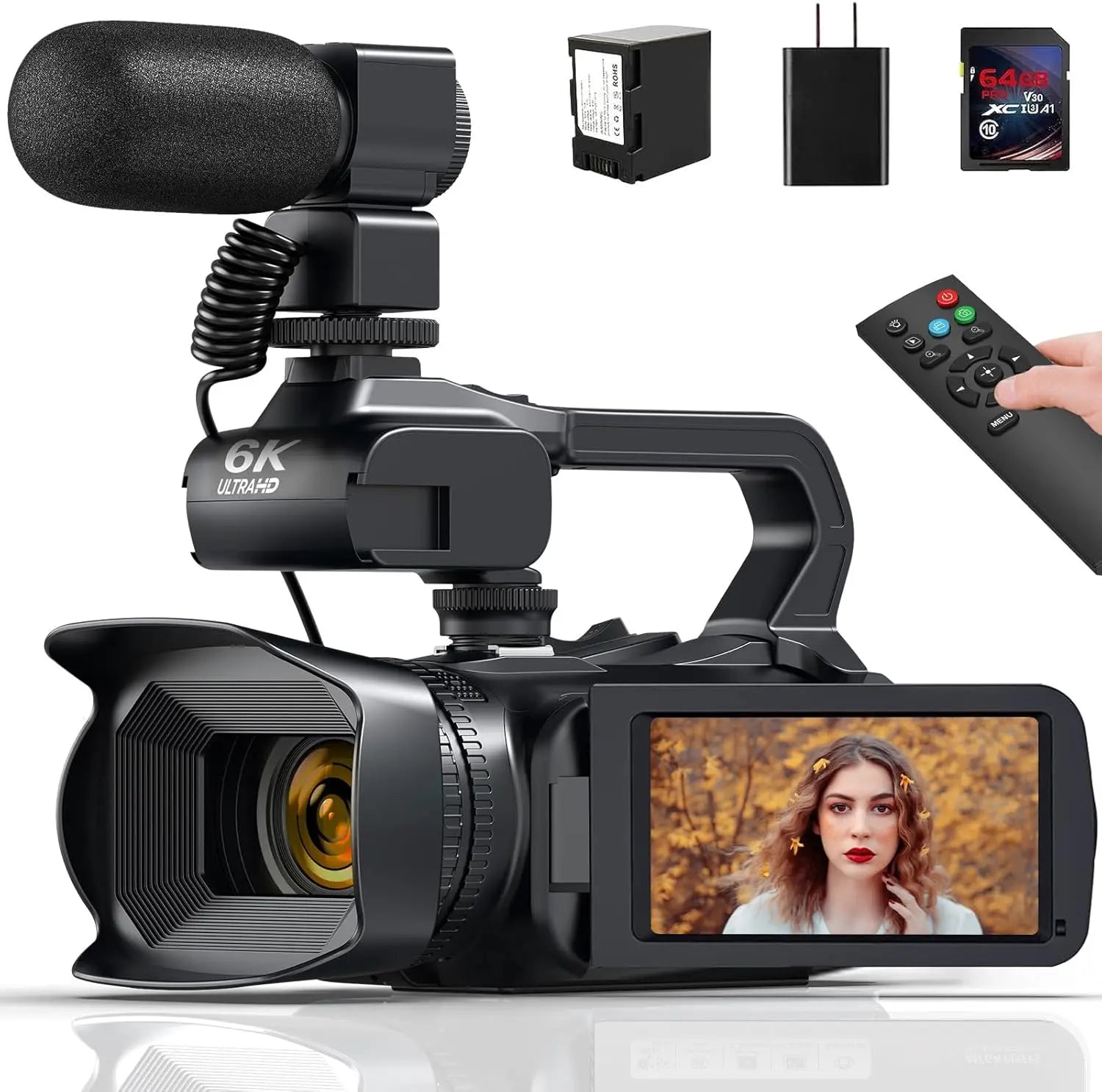 Black 6K video camera with shotgun microphone, remote, battery, charger, and memory card on a white background.