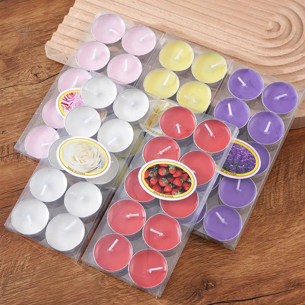 Multi-coloured tea light candles in clear plastic packs, featuring various scents like strawberry, rose, and lavender.