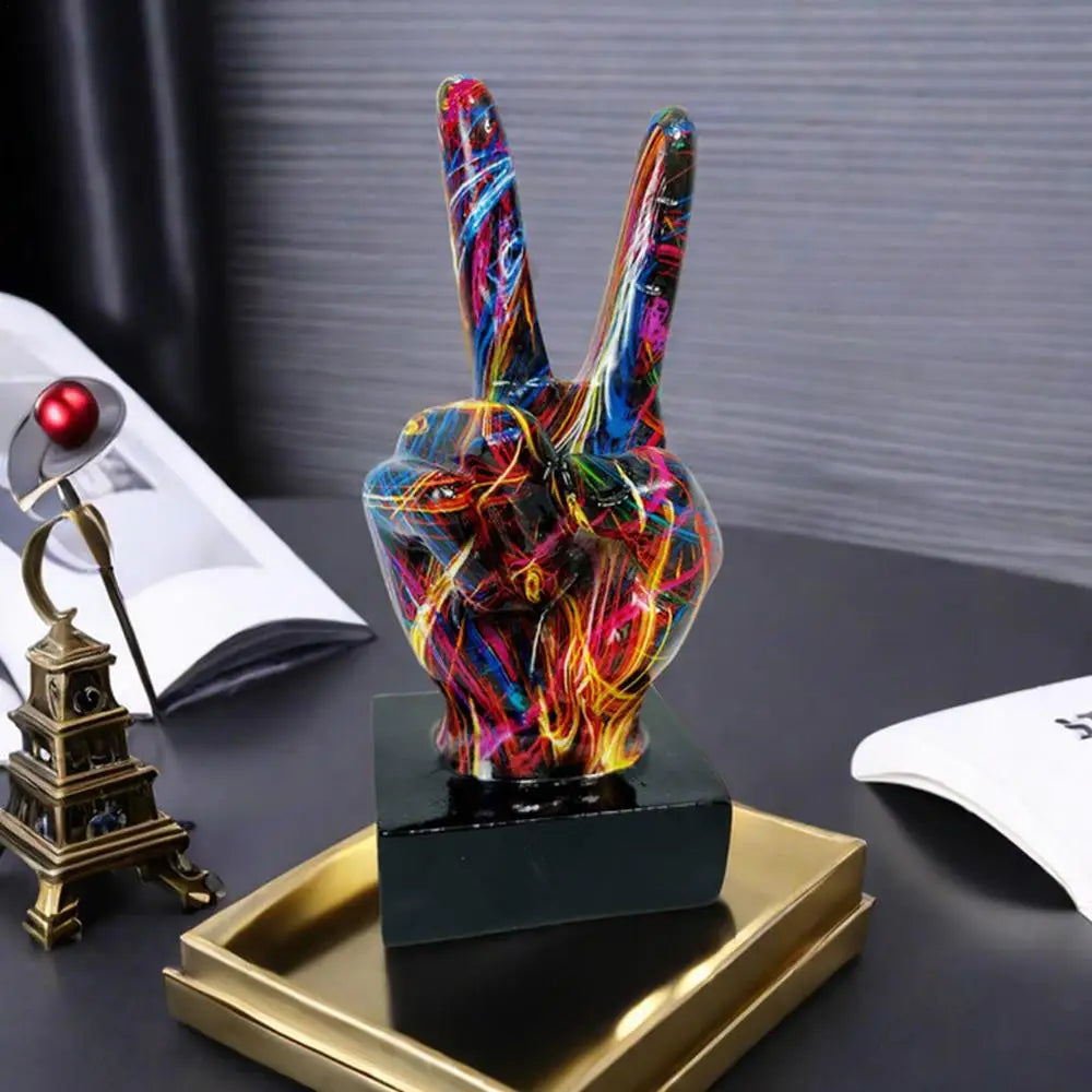 Abstract resin peace sign sculpture with a vibrant, multi-coloured paint splatter finish on a square black base.
