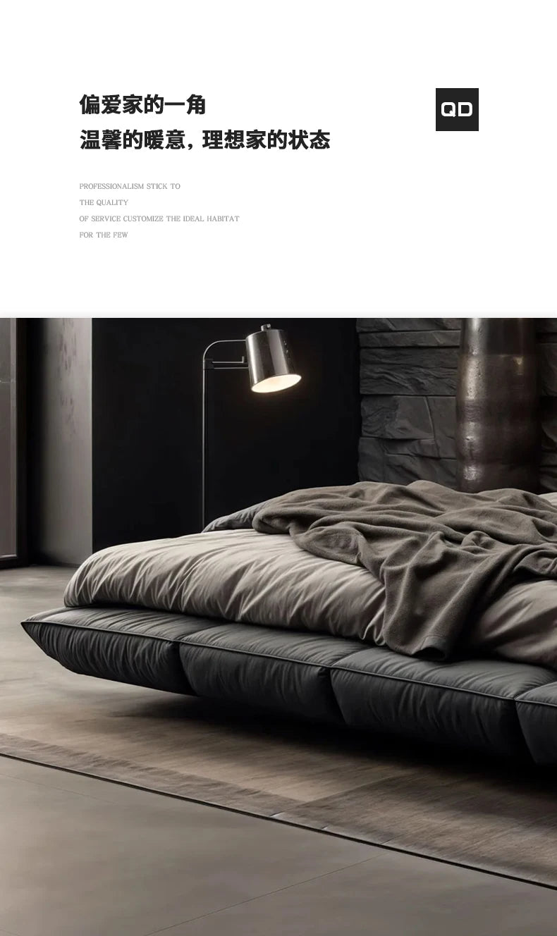Modern dark grey leather floating king-size bed with minimalist quilted frame, styled in a contemporary bedroom.
