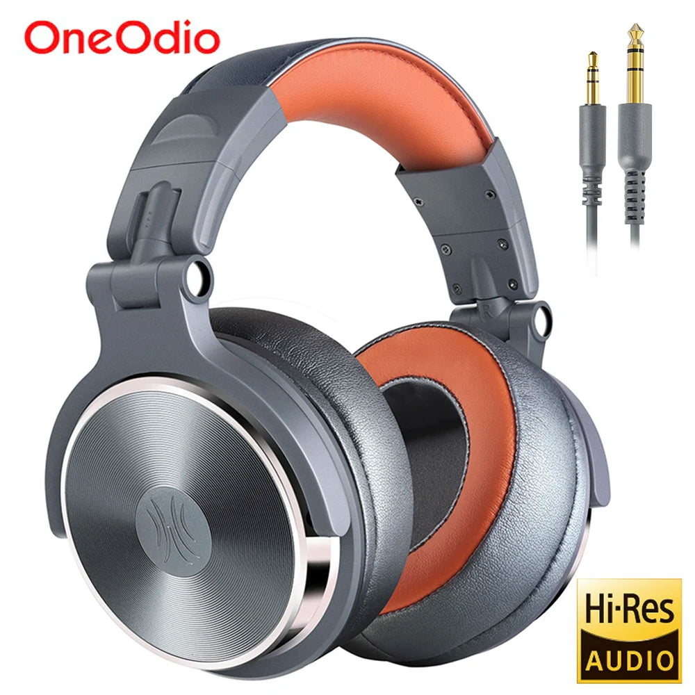 Grey and orange over-ear studio headphones with a foldable design, cushioned headband, and included audio cables.
