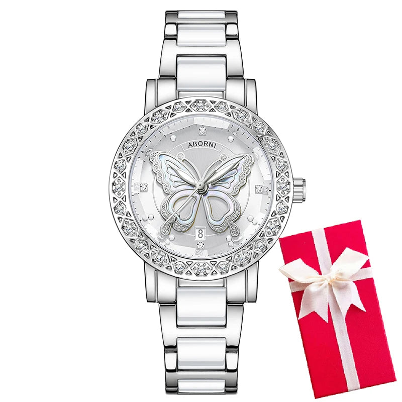 Luxury women’s silver and white ceramic watch with a diamond-set bezel, butterfly dial motif, and red gift box.
