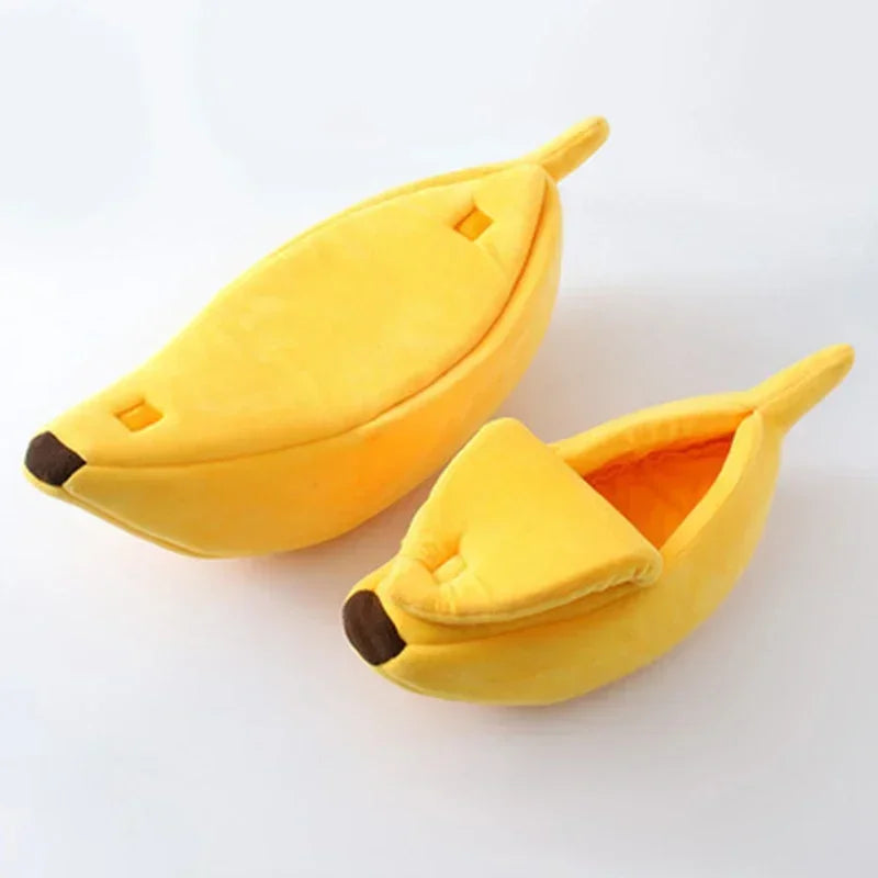 Two yellow banana-shaped plush pet beds with brown tips, one closed and one with a peeled-back flap.