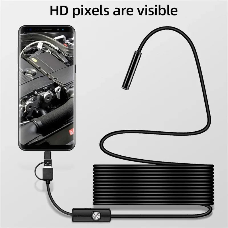 Black endoscope inspection camera with LED lights, connected to a smartphone showing a clear engine bay view.