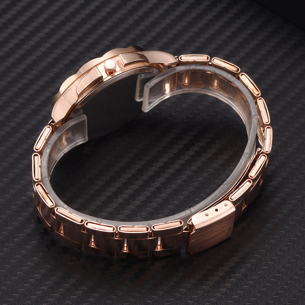 Elegant ladies' rose gold stainless steel watch with a polished link bracelet, shown from the side on a black surface.