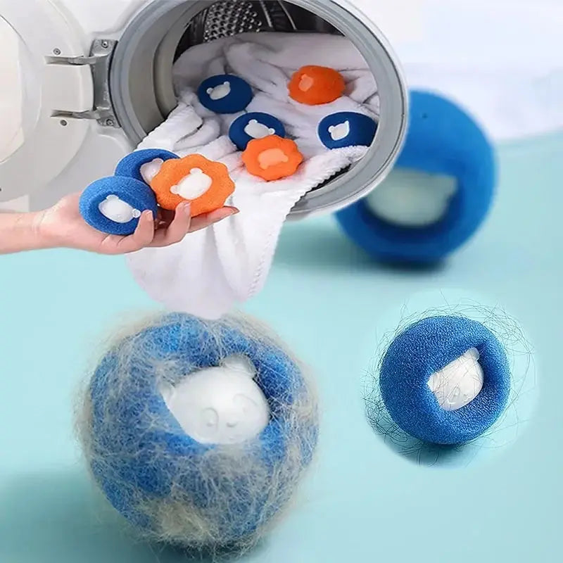Hand holding blue and orange flower-shaped laundry pet hair remover balls in front of a washing machine.