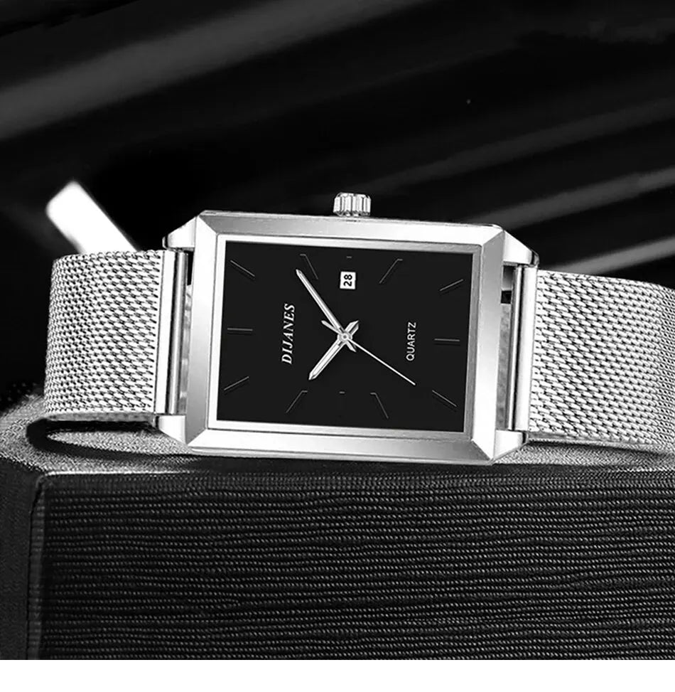 Men’s square quartz watch with a black dial, silver hands and a stainless steel mesh strap.