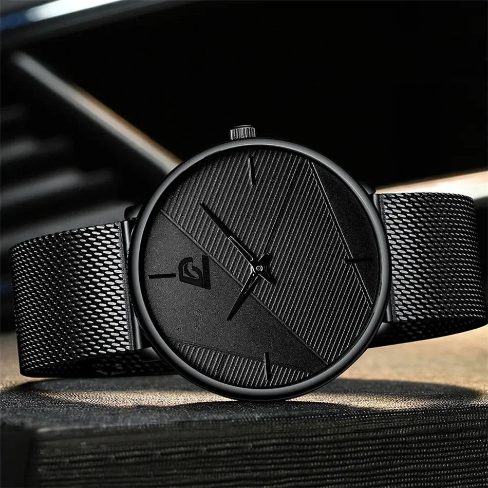 Minimalist men’s ultra-thin quartz watch in matte black, featuring a textured geometric dial and mesh metal strap.