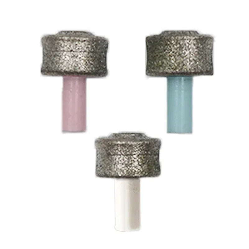 Three replacement grinding heads for a pet nail grinder, featuring silver textured wheels with pink, blue, and white stems.