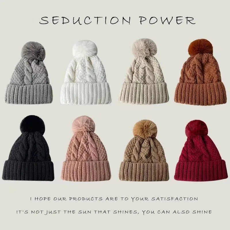 Eight ladies' cable-knit winter beanies with pom-poms, available in a variety of colours including grey, white, and red.