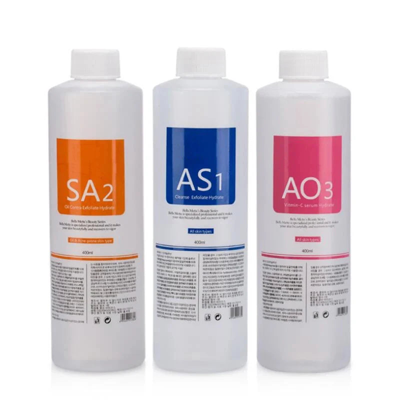 Three 400ml professional skincare bottles with orange, blue, and pink labels for cleansing and hydrating treatments.