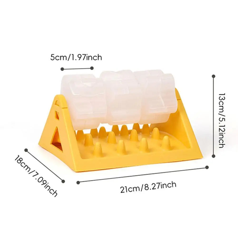 Yellow dog puzzle feeder with three translucent, rotating treat containers over a spiked slow-feeder base.