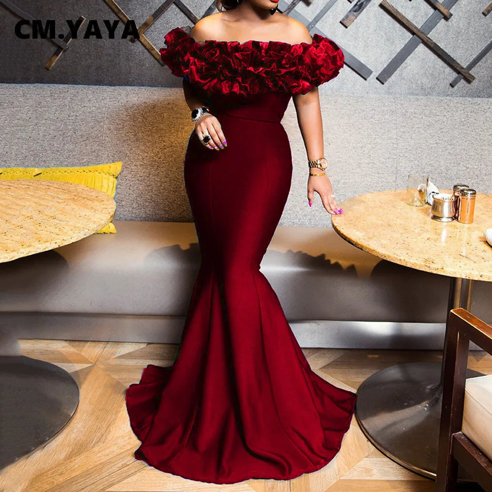Burgundy off-the-shoulder mermaid maxi dress with voluminous ruffles along the neckline and fitted silhouette.